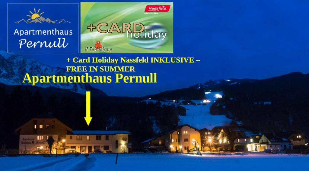 a view of a resort at night with the words card holiday needed inclusive at Apartmenthaus Pernull in Tröpolach