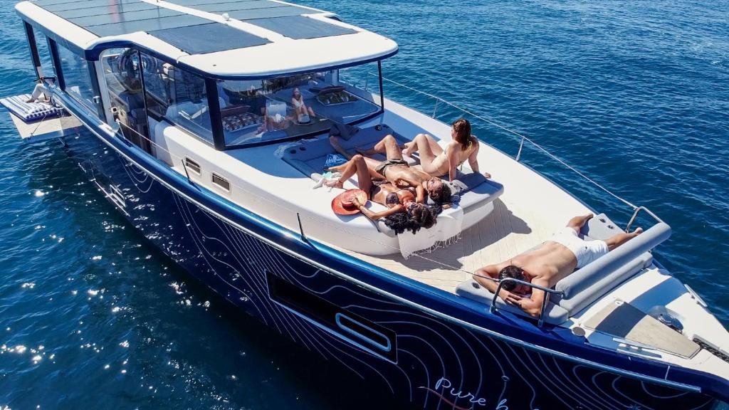 a group of people laying on a boat in the water at Aquaïa, Saint-Tropez by sea in Cogolin
