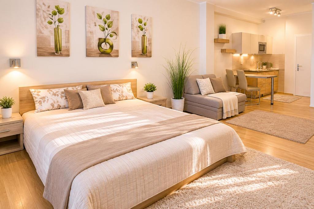 a bedroom with a large bed and a living room at Andy's Home Central Apatment in Budapest