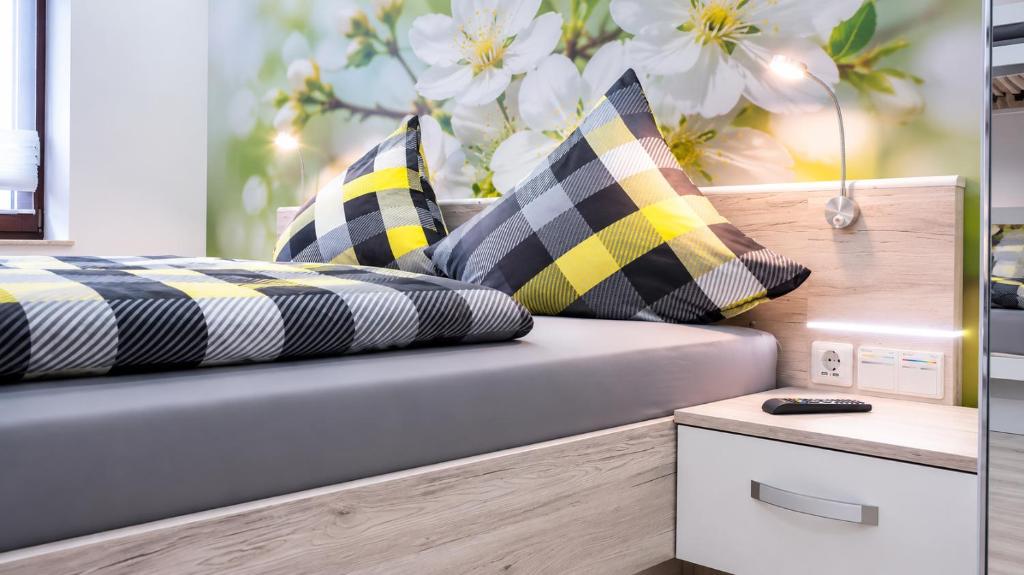 a room with a couch with pillows on it at Hotel Garni Silberburg - Schwarzwald-Plus Karte in Bad Wildbad