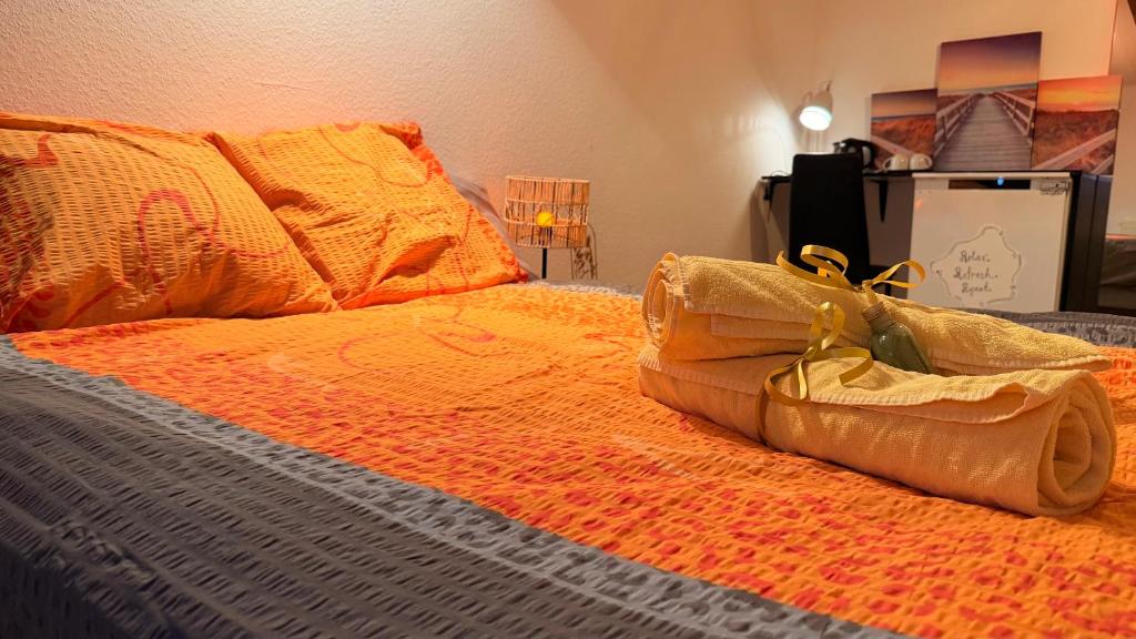 a bed with two pairs of shoes on it at Golden Boutique in Basel