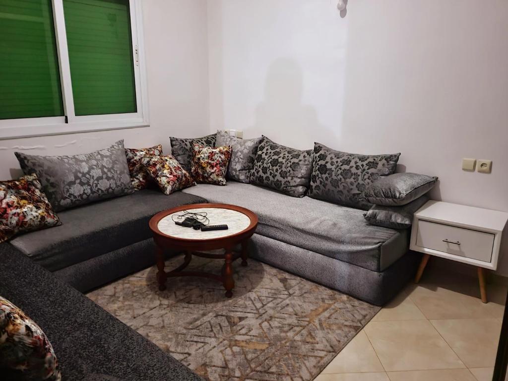 a living room with a couch and a table at عين السلطان ain sultan in Imouzzer du Kandar
