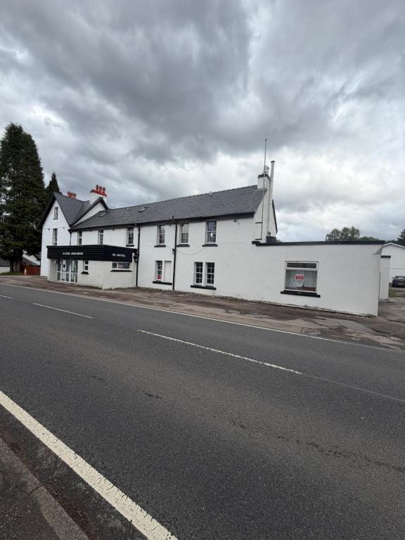 a white building on the side of a road at OX Hotel Spean Bridge in Spean Bridge