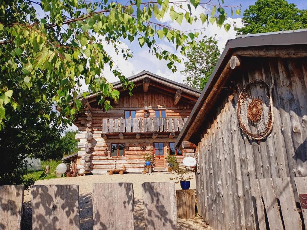 a log cabin with a balcony on top of it at Lagarta La Fuste in Étival