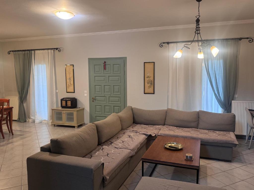 a living room with a couch and a table at Bruskos Holiday Deluxe in Kynopiástai