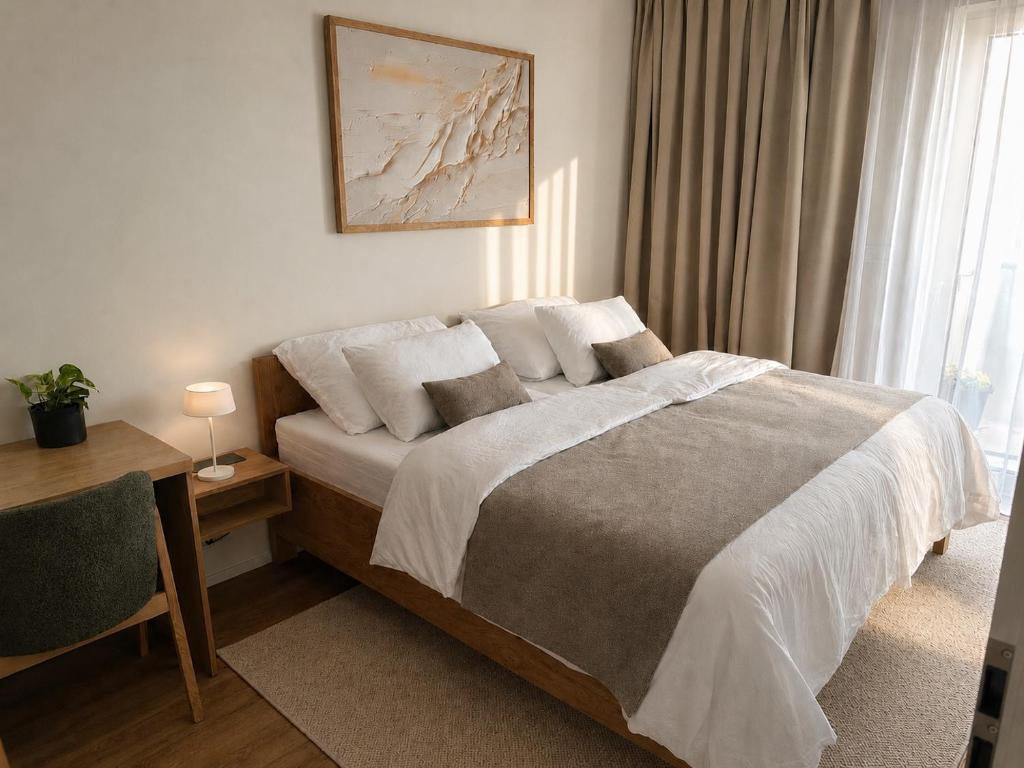 a bedroom with a bed and a desk and a window at Sleep & coffee by KAFEC in Komárov