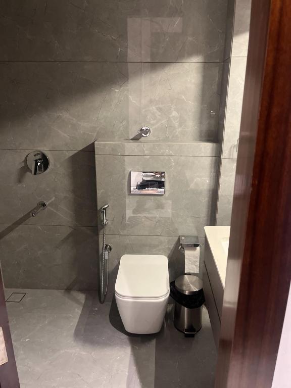 a bathroom with a white toilet and a sink at Hotel route 54 in Bathinda