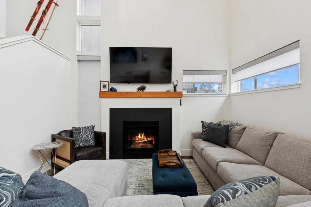 a living room with a couch and a fireplace at Quarry B8 in Whitefish