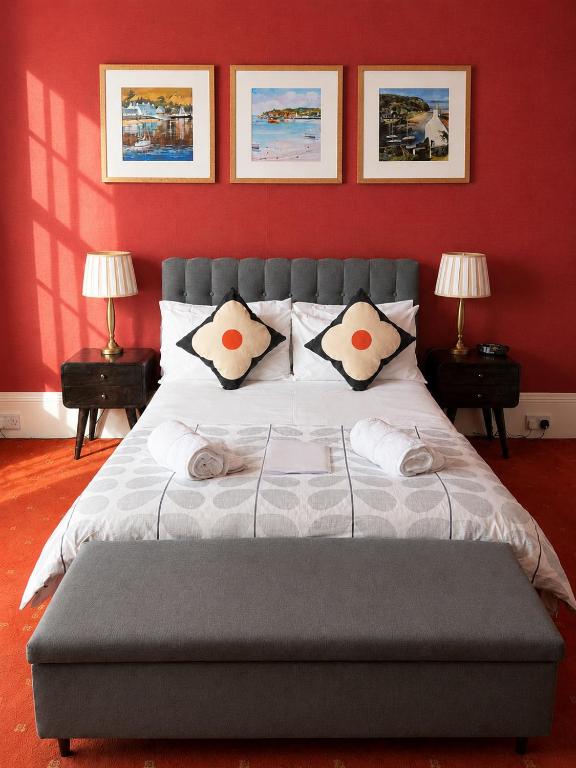 a bedroom with a large bed with red walls at Gladstone House in Edinburgh