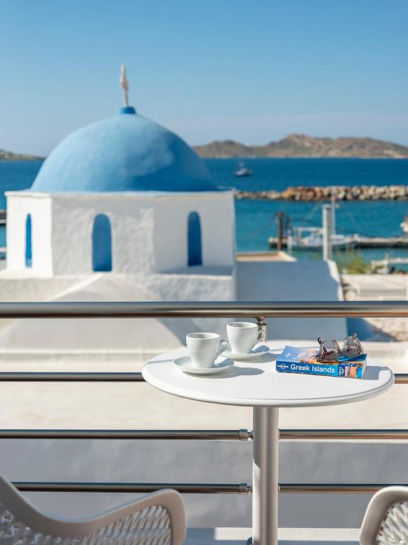 a table with two cups of coffee on top of a ship at Galini Rooms in Naousa