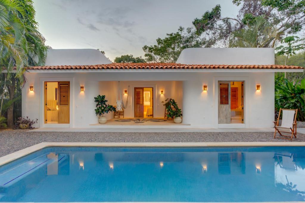 a house with a swimming pool in front of it at Casa Brasil Careyes in Careyes