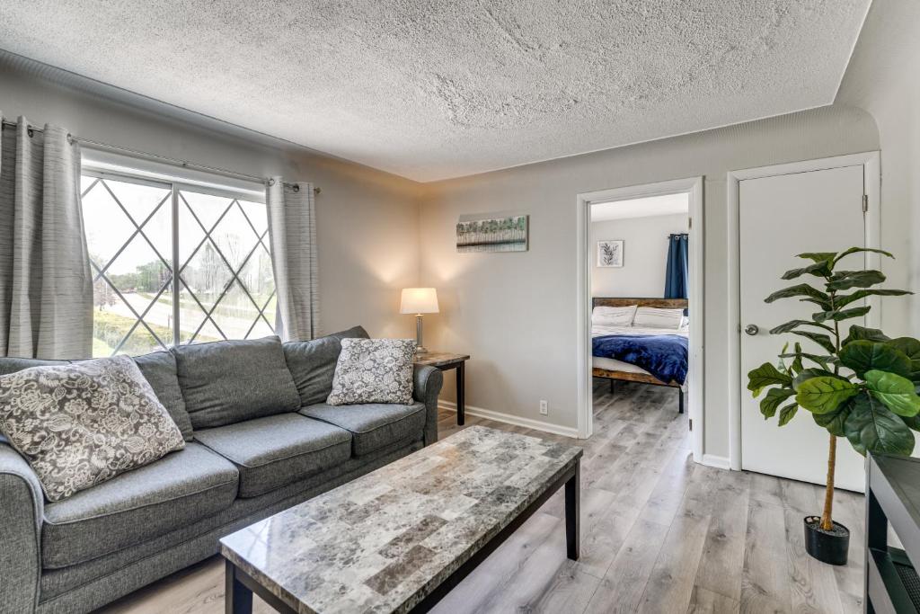 a living room with a couch and a table at Lake Huron Launchpad! Creekfront Condo for Two in Port Huron