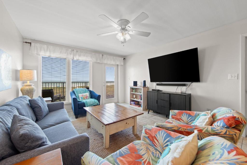 a living room with a couch and a flat screen tv at Edgewater Condo Unit #304 in South Padre Island