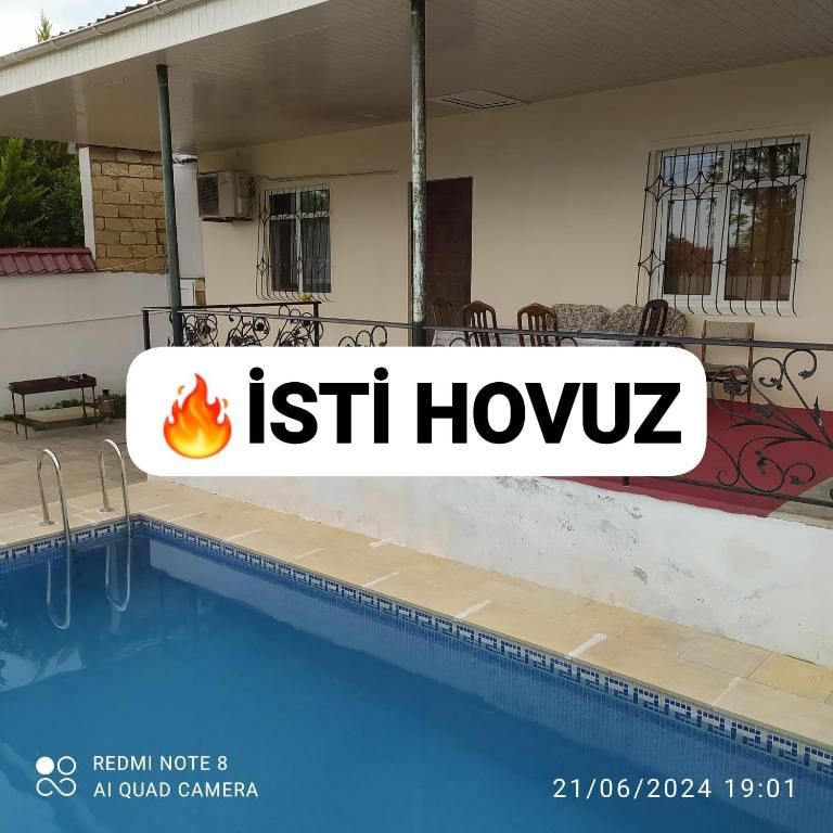 a sign for a house with a swimming pool at Gabala,yard, house in Gabala