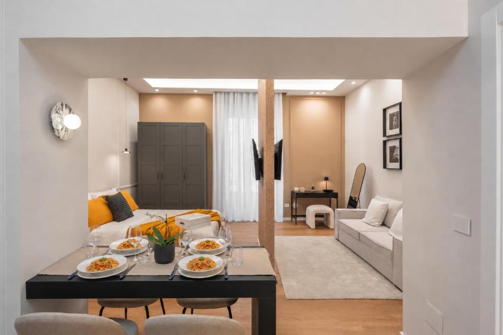 a living room with a table with food on it at Altrove Boutique Studios in Caserta