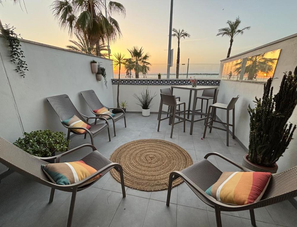 a patio with chairs and a table on a balcony at Arenas de Sanlúcar II in Sanlúcar de Barrameda
