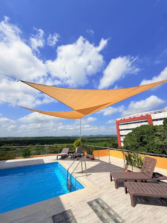 a canopy over a swimming pool on a patio at Hotel Paranawa in Baranoa