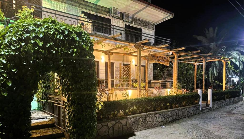 a building with a lit up porch at night at My Afytos Garden in Afitos