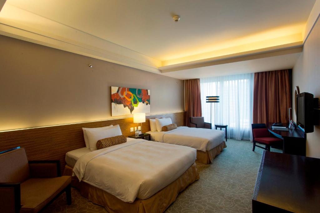 Postel nebo postele na pokoji v ubytování The Bellevue Manila