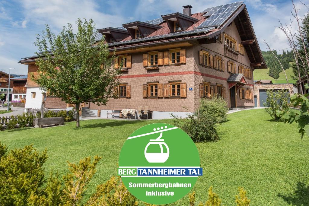 a house with a sign in front of it at Pepi's Landhaus in Schattwald