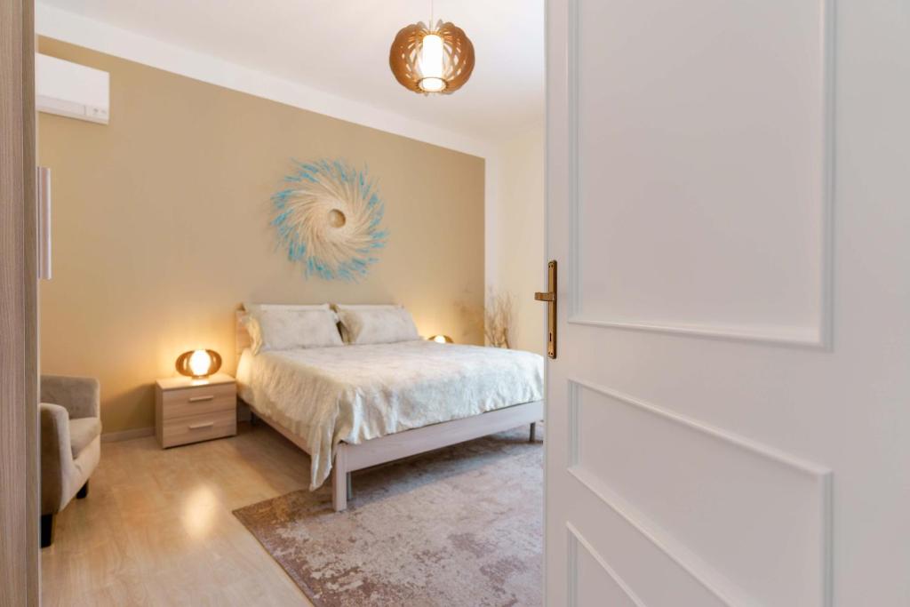 a bedroom with a bed with a blue fan on the wall at Montellinos Suite Tortora in SantʼAntìoco