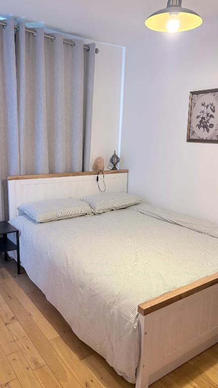 a bedroom with a white bed with a window at Double en-suite in Glin