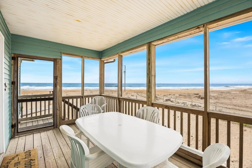 a dining room with a table and chairs on the beach at CAC-3A - Clownfish in Buxton