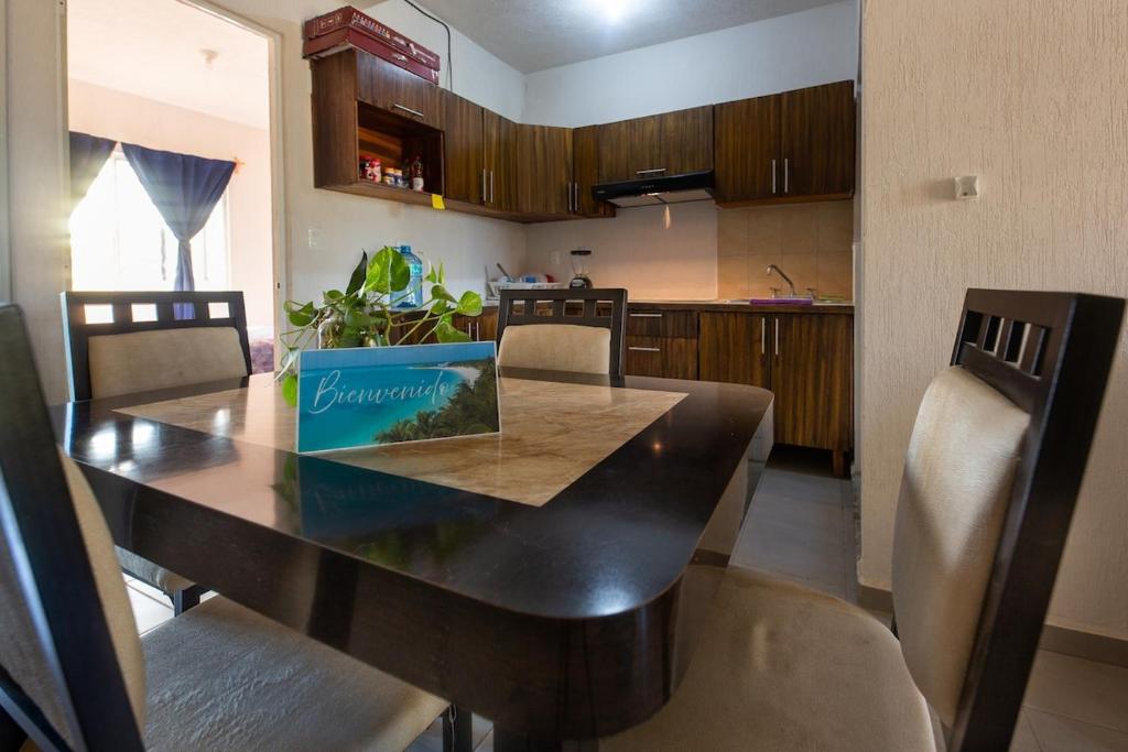 a kitchen with a dining room table with a dining room at Escape Turquesa in Los Algodones