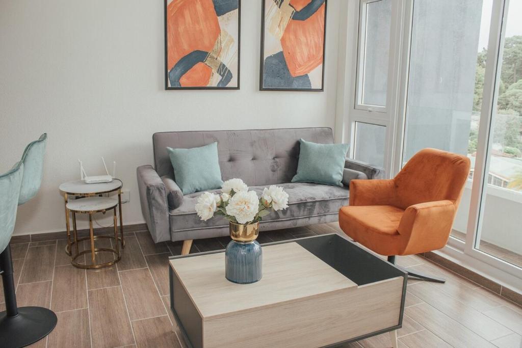 a living room with a couch and a table at Marias Apartment Parque Mateo in El Rodeo