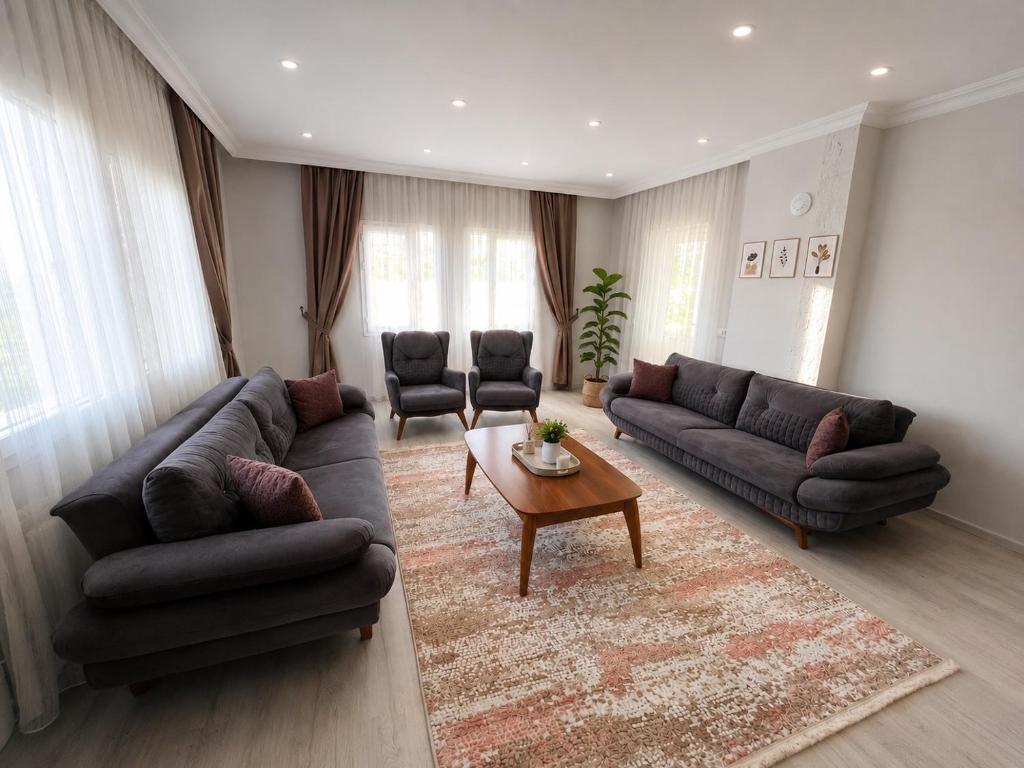 a living room with couches and a coffee table at Apart Portakal Çiçeği in Kaş