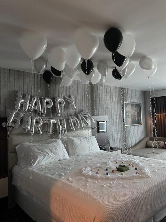 a bed with a bunch of balloons hanging over it at Khelo khaao in Jabalpur