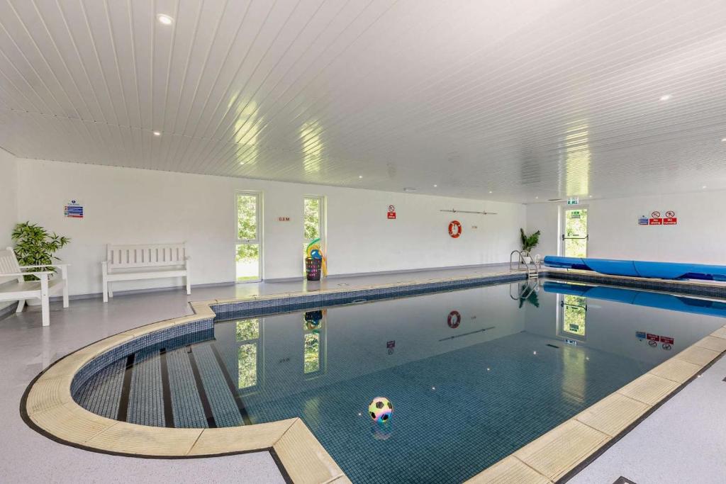 a swimming pool in a large room with a swimming pool at 2 Bed in Beaworthy oc-87085 in Highampton