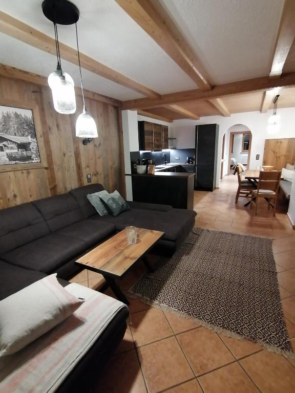 a living room with a couch and a table at Frankenhof in Kössen