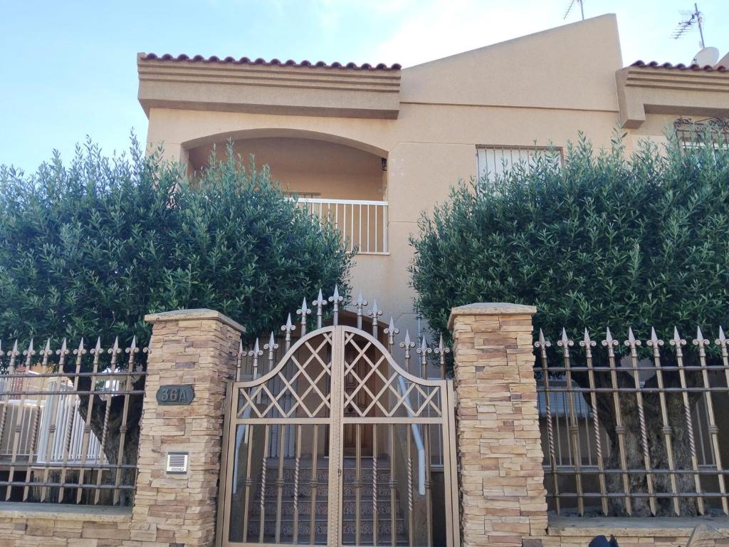a fence in front of a house at Casa de Cope in Calabardina