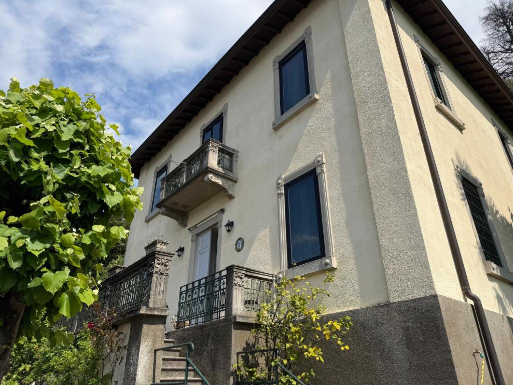 a building with balconies on the side of it at Villa Guardini - Lago di Como in Varenna