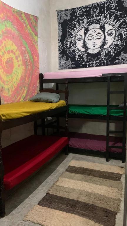 two bunk beds in a room with a wall at Hostel do Rasta in Ubatuba