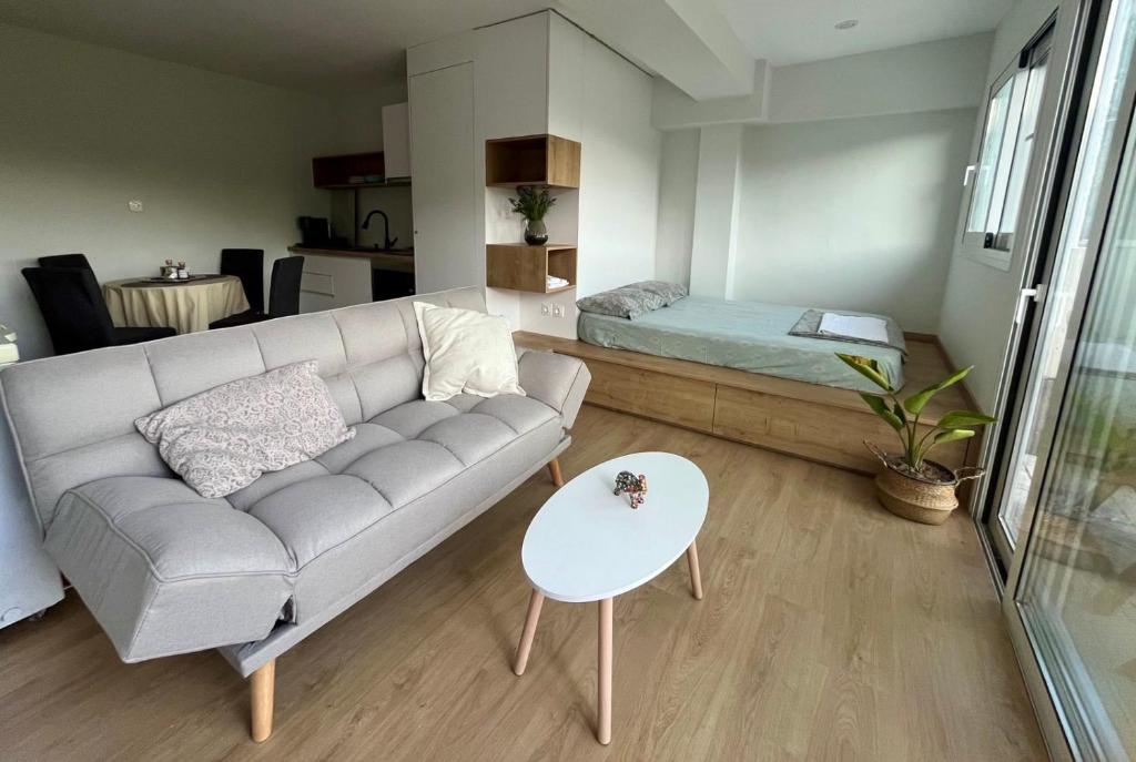 a living room with a couch and a table at Dafni's Nest, Nafpaktos in Nafpaktos
