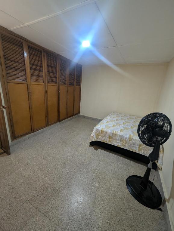 a room with a room with a bed and a spotlight at Olaya Point BAQ in Barranquilla