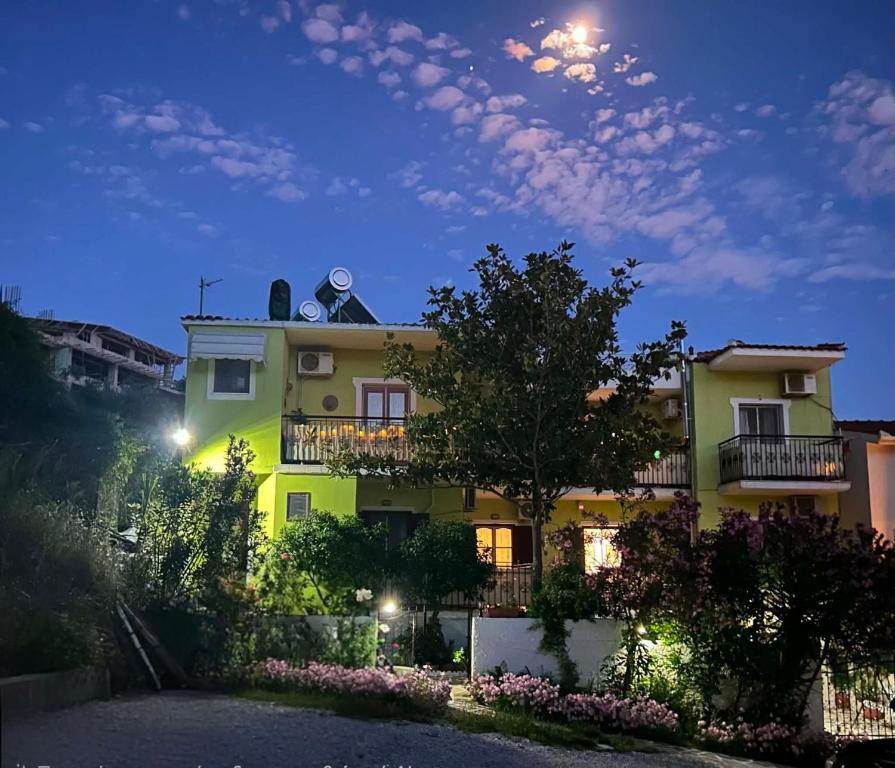 a building with two people on top of it at night at Alexandra's House in Skiathos