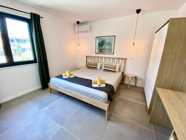 a bedroom with a large bed in a room at Spacious, Newly Renovated, Pula Rooftop Apartment with Marina Views in Pula