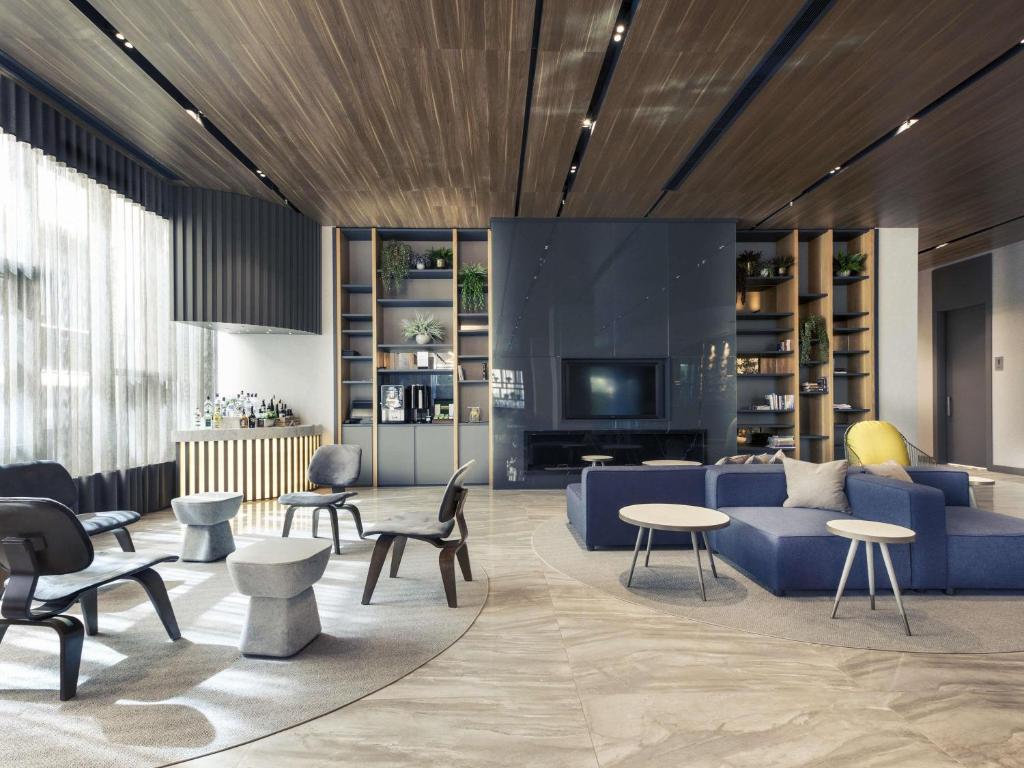 a living room with a couch and chairs and a tv at Mercure Istanbul Umraniye in Istanbul