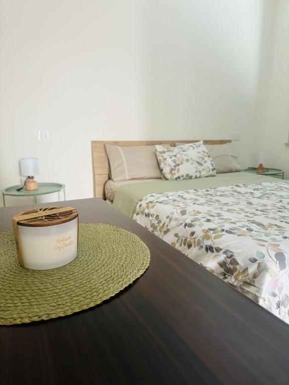 a room with a bed and a bucket on a table at Villa Domini in Soverato Marina