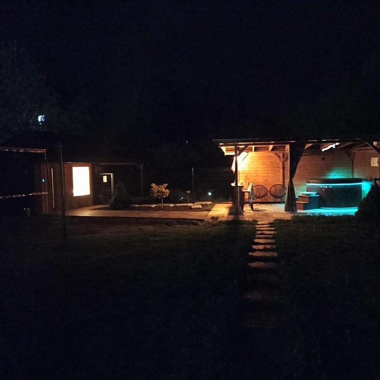 a house at night with blue lights in the dark at Willa Jagoda duży domek w górach 12-15 osób,jacuzzi, kominek,bilard in Zabrzeź