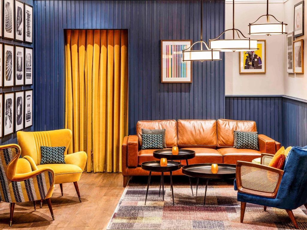 a living room with a couch and chairs at ibis Styles London Gloucester Road in London