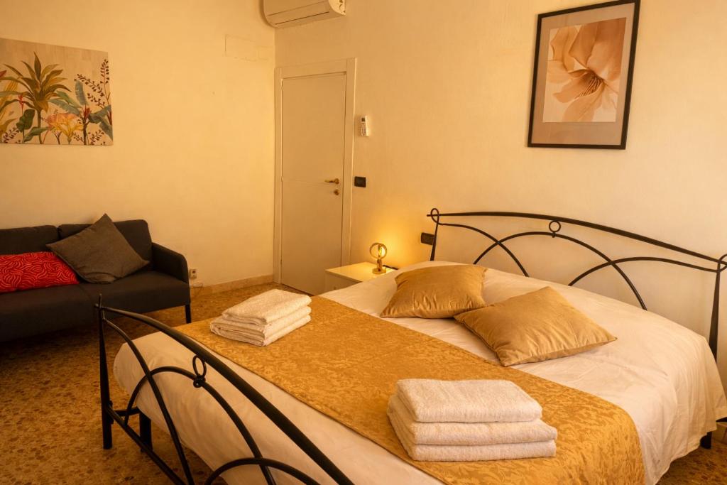 a bedroom with a bed with towels on it at Iris Viola in Bagno a Ripoli