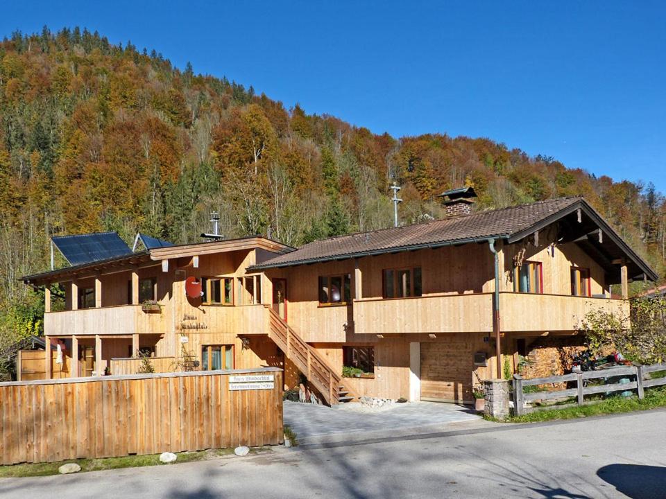 a house with a fence in front of a mountain at Haus Wimbachtal in Ramsau