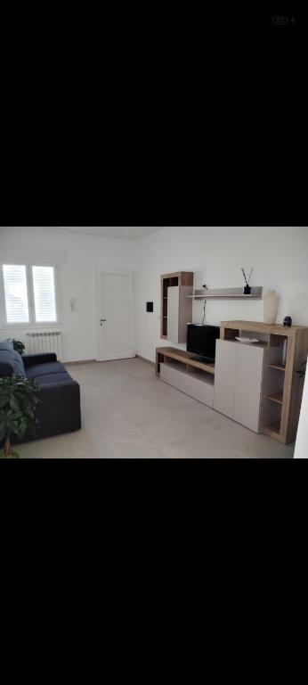 a living room with a bed and a couch at Casa vacanza Lea in Veglie