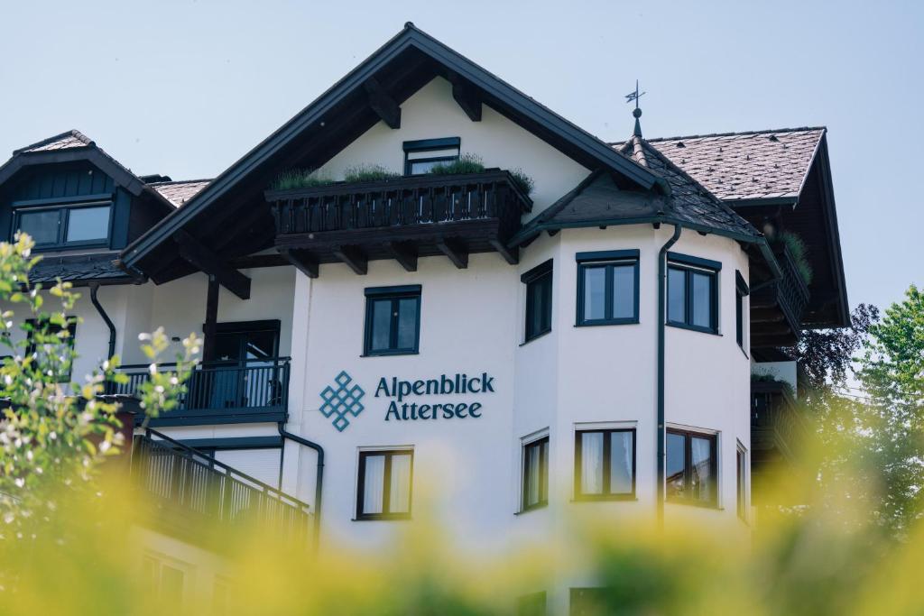 a white building with the akademik antwerp alliance at Hotel Alpenblick Attersee Superior in Attersee am Attersee