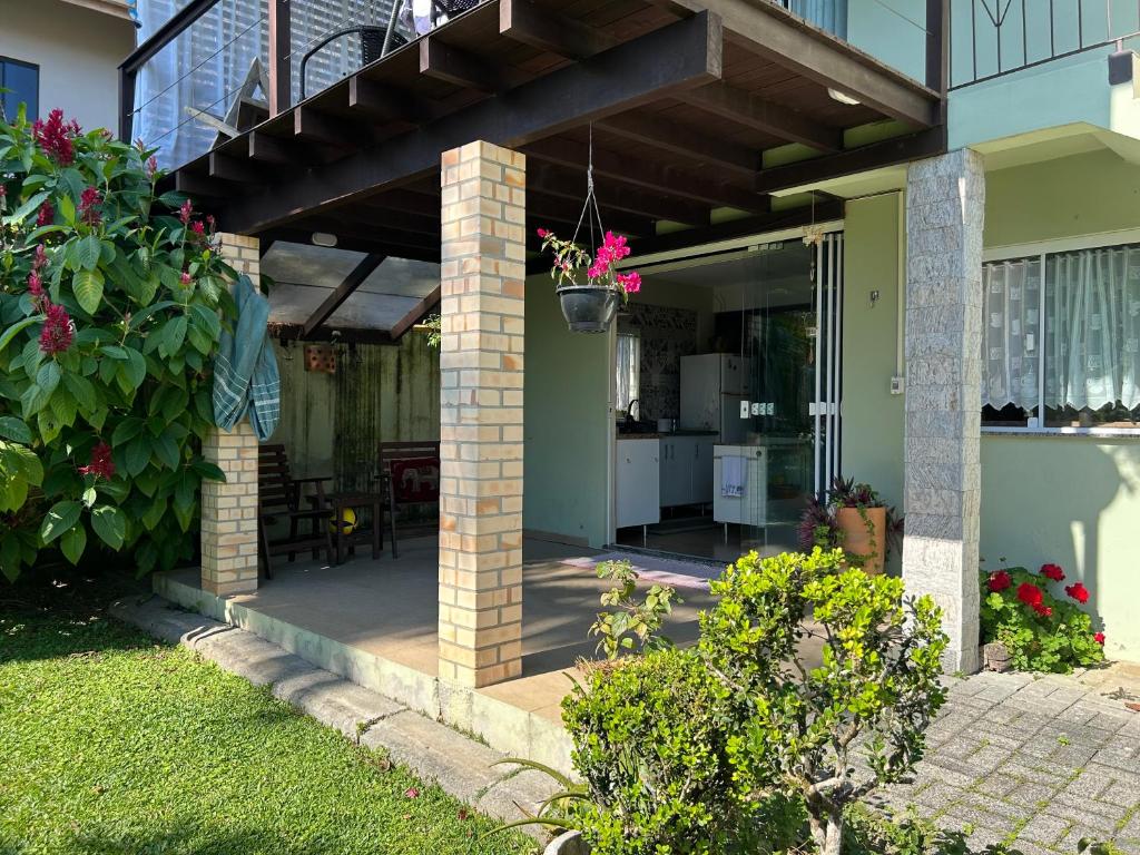 a house with a porch with a patio at Espaço Aconchego in Pomerode