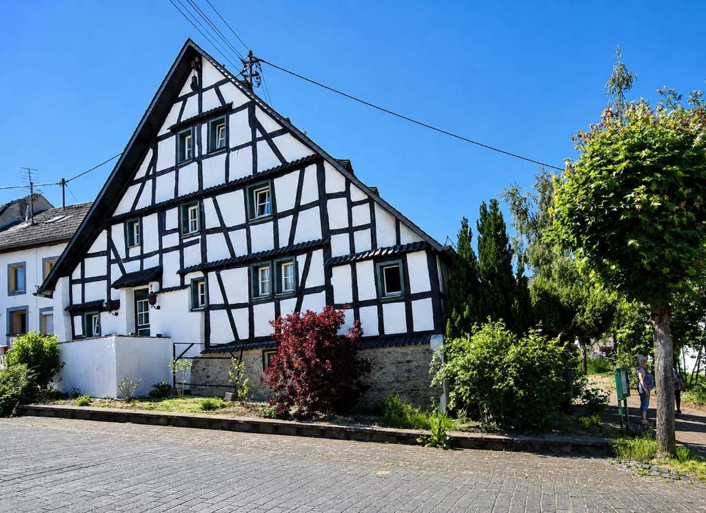 a black and white building on a street at Ferien im Kellisch-Haus in Schalkenmehren